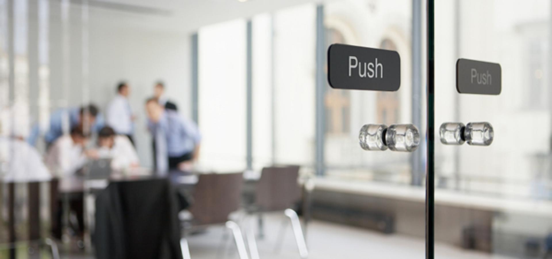 Office meeting behind glass doors